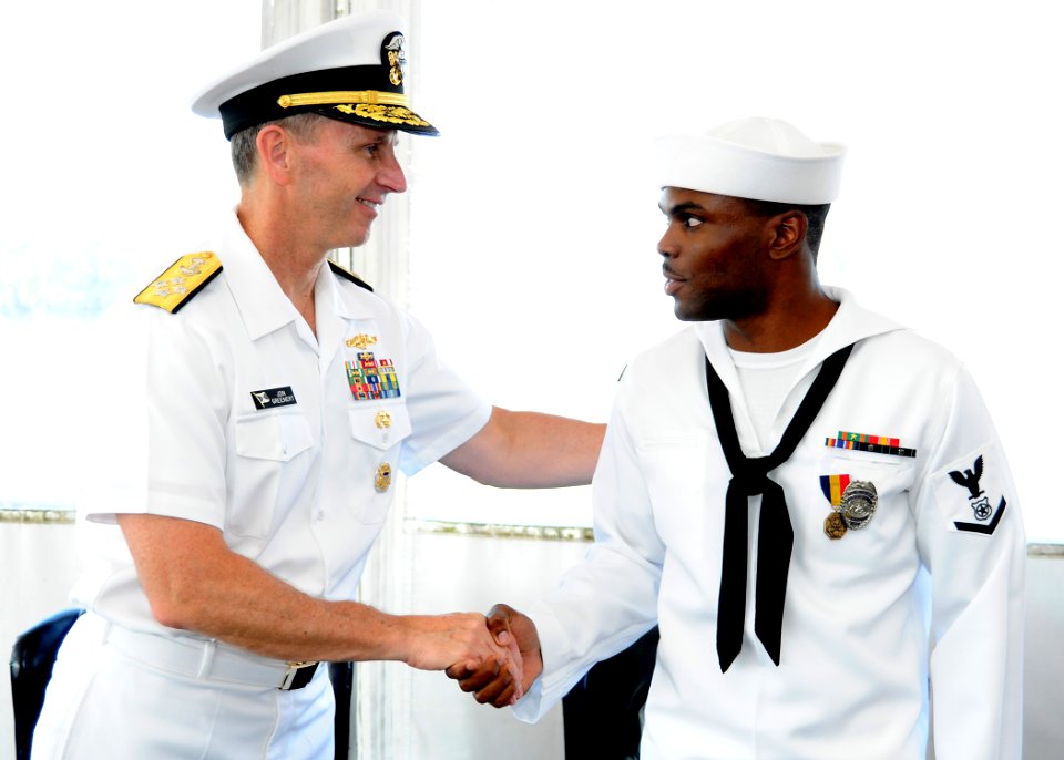 US Navy 110810-N-FC670-021 Vice Chief of Naval Operations (VCNO) Adm. Jonathan Greenert congratulates Master-at-Arms 3rd Class Quentin Benjamin aft