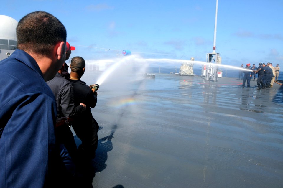 US Navy 110812-N-XG305-816 Chief petty officers compete against Sailors from repair locker 2 in a barrel shoot during a damage control Olympics