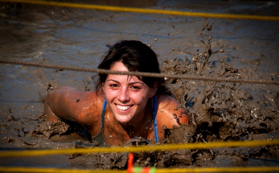 US Navy 110813-N-XS652-558 A runner navigates an obstacle during the 11th annual Armed Services YMCA Mud Run at Joint Expeditionary Base Little Cr