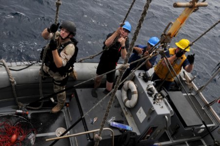 US Navy 110817-N-DU438-348 Sailors hold on as their RHIB is lowered