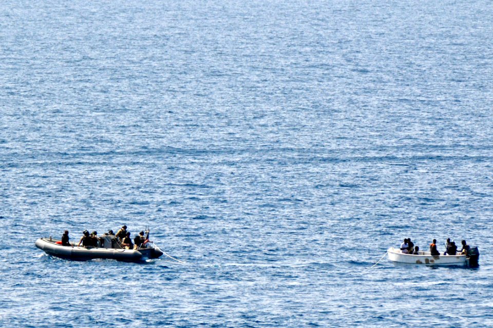 US Navy 110812-N-YM590-132 Members of a visit, board, search and seizure team from the guided-missile cruiser USS Anzio (CG 68) assist mariners abo