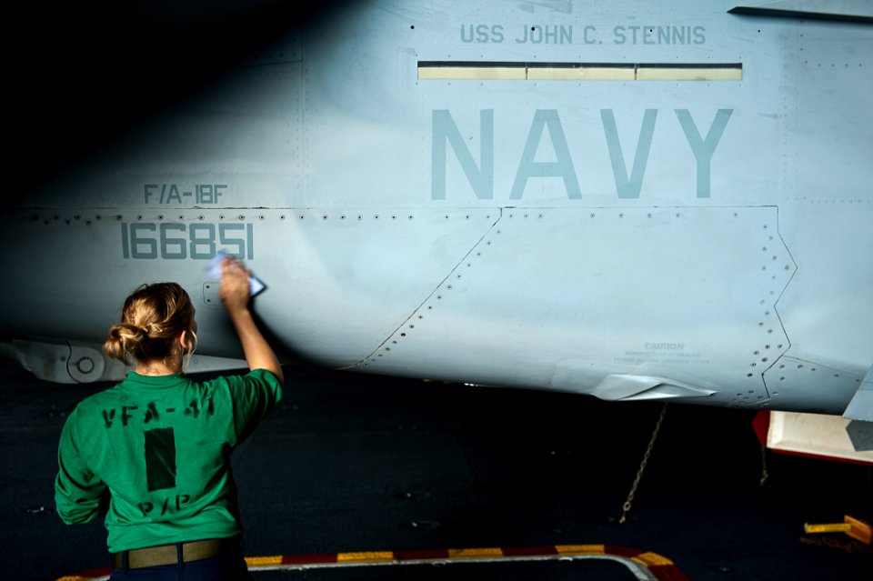 US Navy 110812-N-BT887-303 Aviation Machinist's Mate Lynn Adrian wipes down an F-A-18F Super Hornet