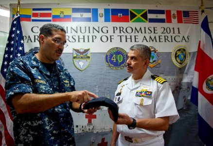 US Navy 110810-N-RM525-308 Commodore Brian Nickerson, mission commander for Continuing Promise 2011, hands Costa Rican Coast Guard Director photo