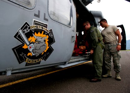 US Navy 110810-N-RM525-815 Chief Naval Air Crewman Justin Crowe prepares an injured boy for transport by local paramedics in San Jose, Costa Rica photo