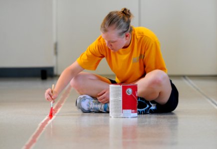 US Navy 110812-N-GS507-971 Cryptologic Technician (Networks) Seaman Megan Harrick, from Noblesville, Ind., paints a walking path in a hallway at O