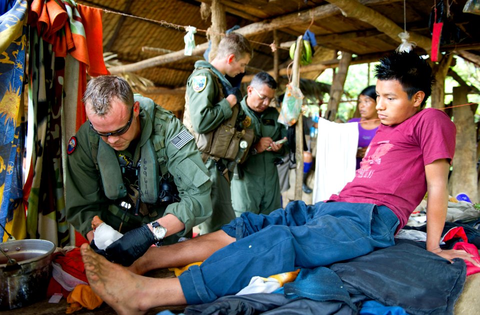 US Navy 110810-N-RM525-494 Chief Naval Air Crewman Justin Crowe bandages a gunshot wound on a boy's foot in Bajo Blay, Costa Rica