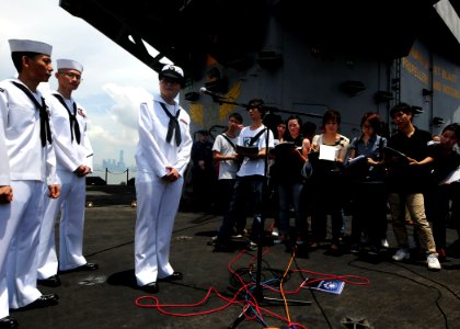 US Navy 110812-N-SB672-250 Sailors speak with Chinese media members in Cantonese aboard the aircraft carrier USS Ronald Reagan (CVN 76)