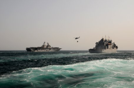 US Navy 110812-N-XQ375-836 An SH-60 Sea Hawk helicopter transfers pallets of stores from the USNS Wally Schirra (T-AKE 8) to the USS Boxer (LHD 4)