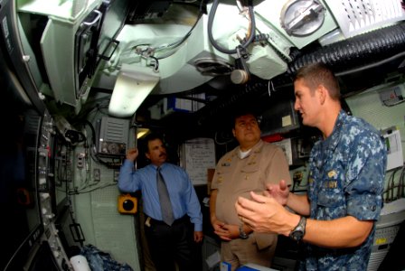 US Navy 110815-N-NK458-018 Cmdr. T.R. Buchanan, commanding officer of the Los Angeles-class attack submarine USS Albany (SSN 753), explains sonar r