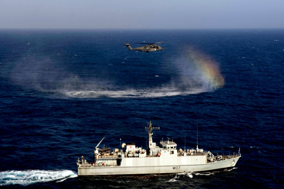 US Navy 110816-N-YX920-113 An SH-60 Sea Hawk helicopter assigned to Helicopter Mine Countermeasures Squadron (HM) 15 flies alongside the Royal Navy