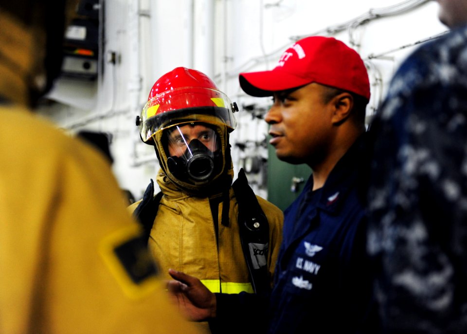US Navy 110813-N-ED900-456 Hose team members listen to instructions on basic firefighting skills during a general quarters drill