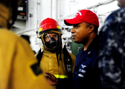 US Navy 110813-N-ED900-456 Hose team members listen to instructions on basic firefighting skills during a general quarters drill
