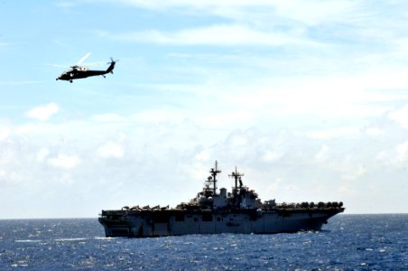 US Navy 110818-N-GW695-086 A Sea Hawk flies over the USS Boxer in the Indian Ocean