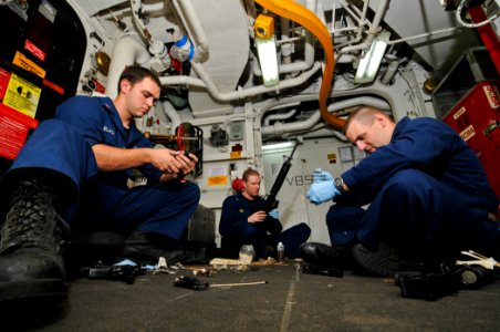 US Navy 110815-N-YM590-041 Sailors clean weapons on the USS Anzio