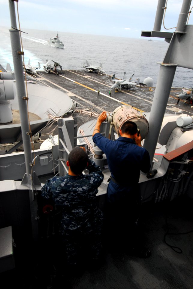 US Navy 110812-N-AW206-037 Quartermaster Seaman Chris Jurado, left, from Pamona, Calif., and Quartermaster 3rd Class Elvis Ortiz, from Bronx, N.Y