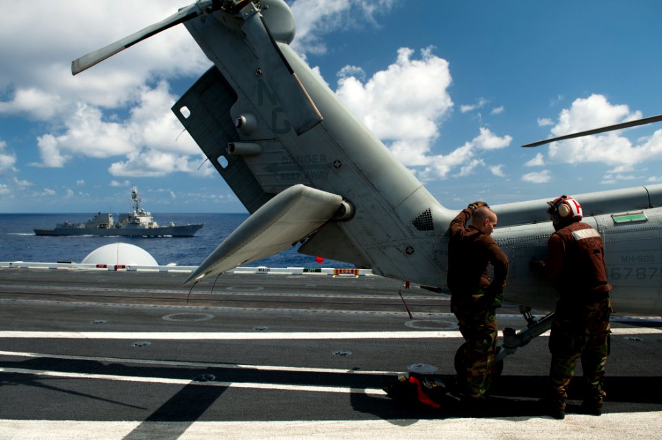 US Navy 110816-N-BT887-102 Sailors secure the tail of an MH-60S Sea Hawk helicopter assigned to Helicopter Sea Combat Squadron (HSC) 8