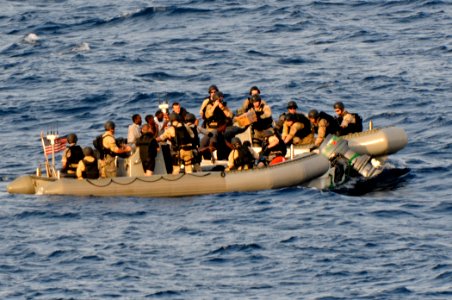 US Navy 110812-N-YM590-396 Members of a visit, board, search and seizure team from the guided-missile cruiser USS Anzio (CG 68) assist mariners abo