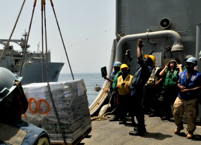 US Navy 110815-N-AG285-340 Sailors receive pallets carrying supplies during a replenishment at sea aboard the amphibious dock landing ship USS Whid
