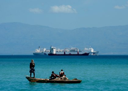 US Navy 110818-N-NY820-132 Haitian fishermen look toward the Military Sealift Command hospital ship USNS Comfort (T-AH 20) during Continuing Promis photo