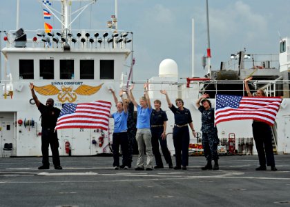 US Navy 110815-N-NY820-373 Service members and civilians aboard the Military Sealift Command hospital ship USNS Comfort (T-AH 20) wave at the camer