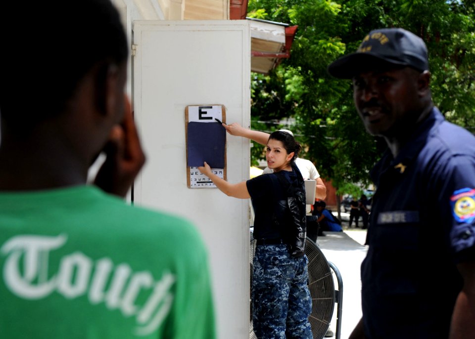 US Navy 110818-F-ET173-130 Hospital Corpsman 2nd Class Amanda Fletcher, from Lancaster, Calif., conducts an eye exam