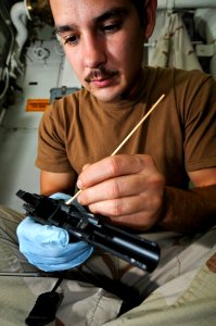 US Navy 110815-N-YM590-047 Sailors from the VBSS team clean weapons