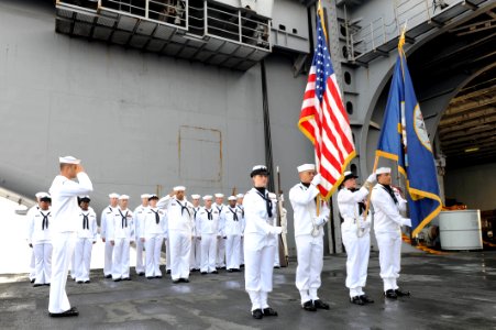 US Navy 110818-N-AU622-049 Sailors selected for advancement to chief petty officer stand at attention with members of the honor guard while photo