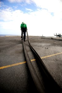US Navy 110812-N-ZZ999-290 AB Miguel Bahena removes slot seals from catapults aboard the USS John C. Stennis