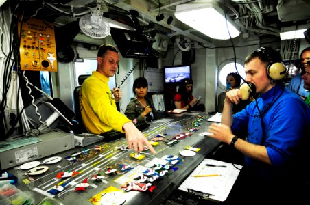 US Navy 110813-N-JO245-024 Lt. Cmdr Eric Harrington shows distinguished visitors from Vietnam the Ouija board in flight deck control aboard the air