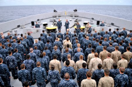 US Navy 110818-N-GW695-584 Sailors, Marines stand at attention on the foc'sle for an all-hands call