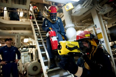 US Navy 110818-N-PB383-106 Damage Controlman 2nd Class Josh Nightengale uses a Naval Firefighter's Thermal Imager (NFTI) to navigate the engine roo