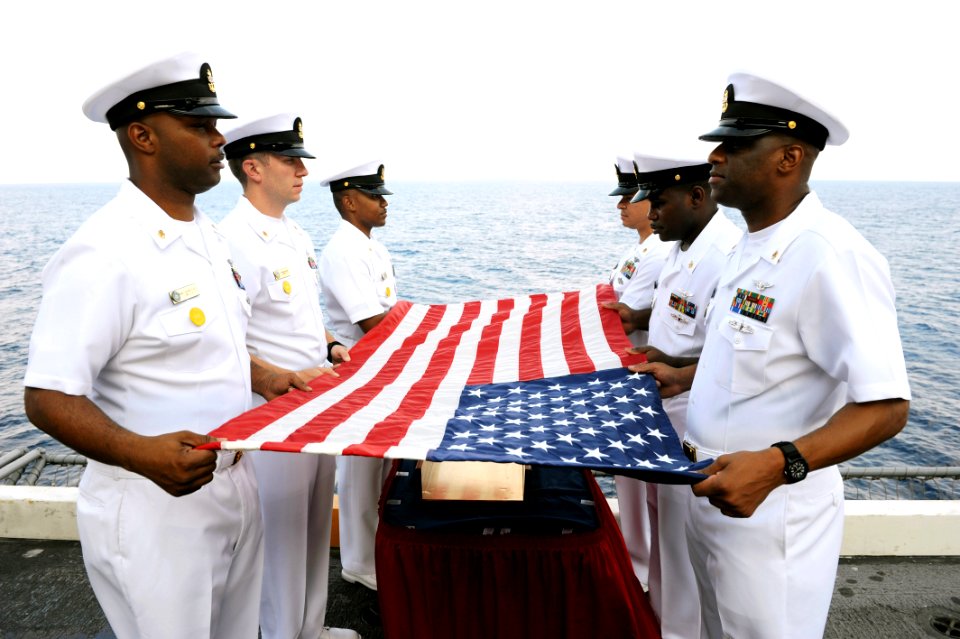 US Navy 110818-N-AU622-013 Chief petty officers prepare a flag for a burial at sea aboard the aircraft carrier USS Dwight D. Eisenhower (CVN 69)