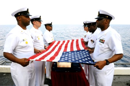 US Navy 110818-N-AU622-013 Chief petty officers prepare a flag for a burial at sea aboard the aircraft carrier USS Dwight D. Eisenhower (CVN 69) photo