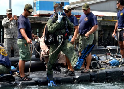 US Navy 110818-N-VA590-136 Navy Diver 2nd Class Ryan Arnold, assigned to Mobile Diving and Salvage Unit (MDSU) 2, jumps into the water at the Vasco