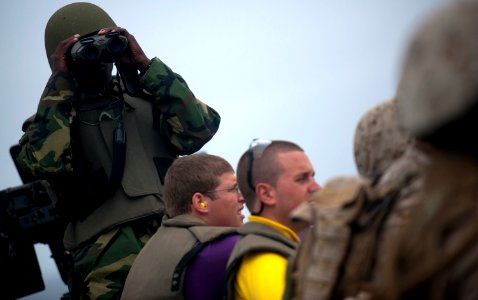 US Navy 110817-N-PB383-002 Logistics Specialist Seaman Rogers Nunnery searches for his target before firing a .50-caliber machine gun aboard the Sa