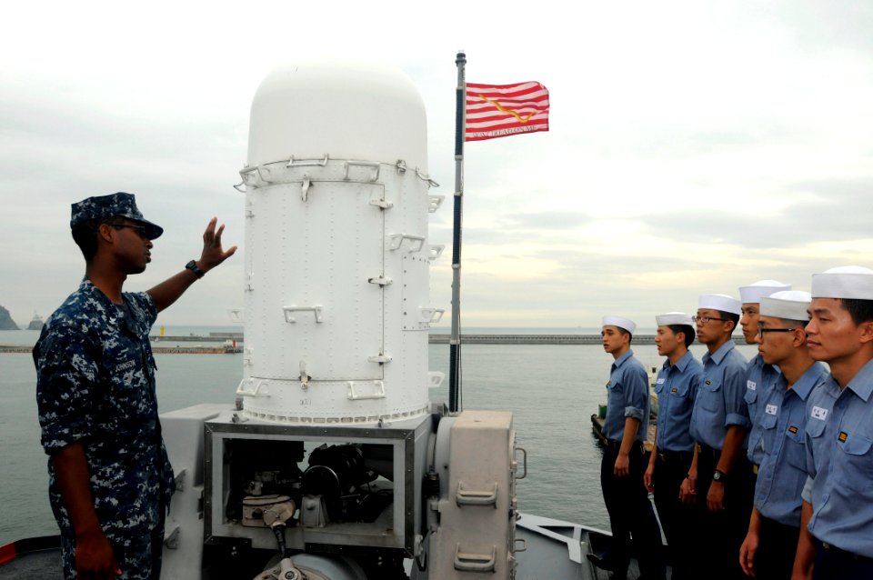 US Navy 110819-N-XG305-209 Fire Controlman 2nd Class Stephen Johnson explains the capabilities of the Phalanx Close-in Weapons System (CIWS) to Rep
