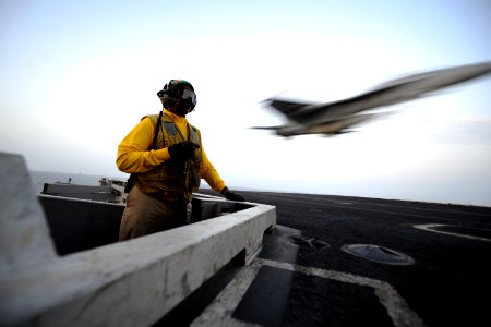 US Navy 110821-N-YZ751-572 The arresting gear officer watches as Super Hornets launch and land on the USS George Bush flight deck