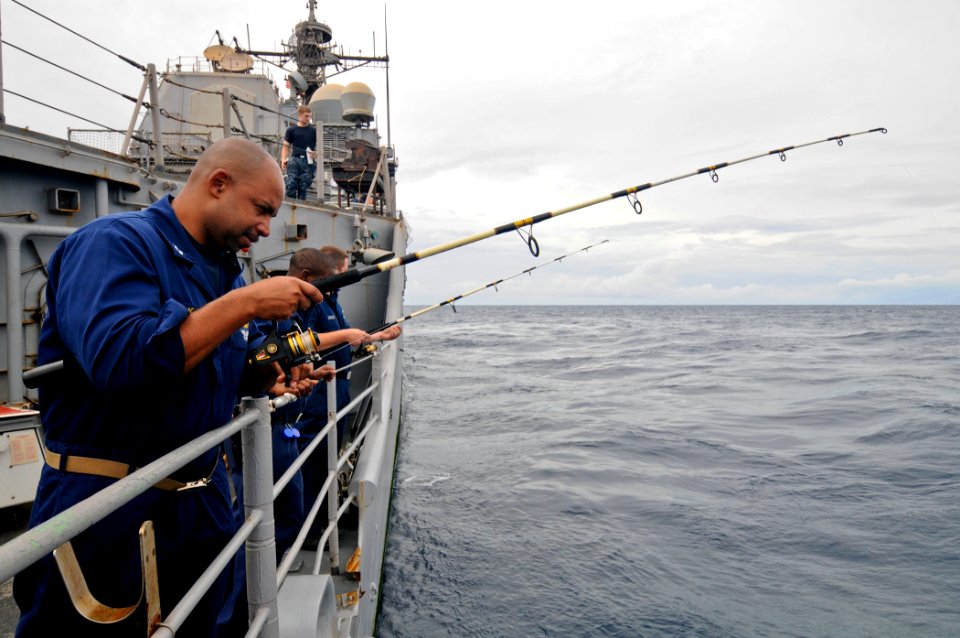 US Navy 110817-N-YM590-001 Sailors fish off the fantail