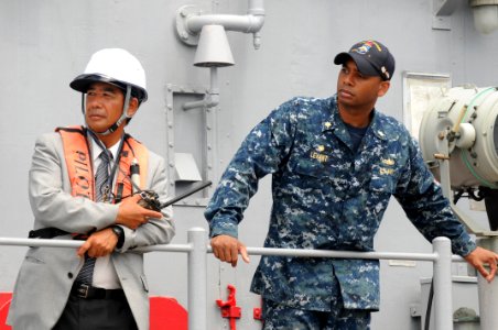 US Navy 110815-N-SP676-138 Lt. Cmdr. Todd S. Levant observes sea and anchor detail aboard the mine countermeasures ship USS Defender (MCM 2) with t