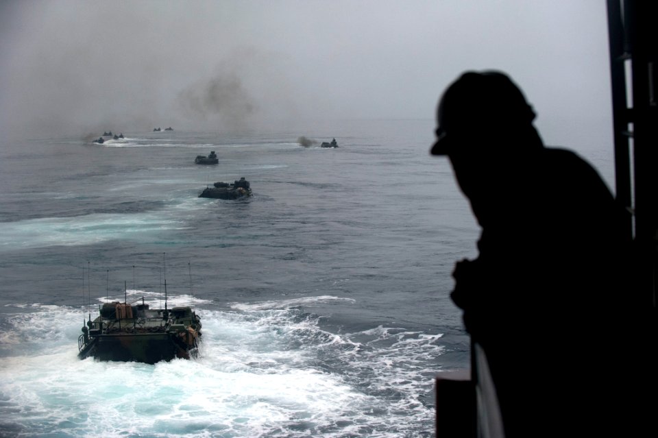 US Navy 110815-N-PB383-005 A Sailor watches amphibious assault vehicles depart the well deck of the San Antonio-class amphibious transport dock shi