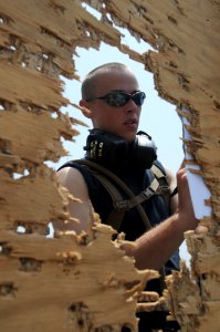 US Navy 110815-N-XQ375-746 Gunner's Mate 2nd Class Travis Kaizen tallies shooting scores during an M16 rifle qualification
