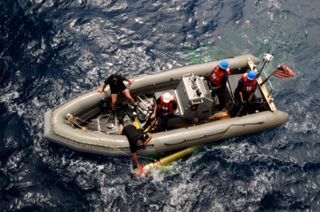 US Navy 110822-N-XQ375-624 Sailors in a rigid-hull inflatable boat from the guided-missile destroyer USS Mitscher (DDG 57) recover a MK-46 recovera photo