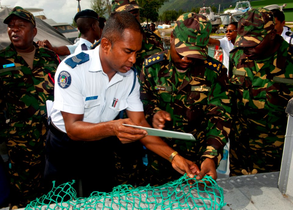 US Navy 110817-N-OV802-036 Mauritian and Tanzanian sailors measure fishing nets during a fisheries training course aboard the Seychelles coast guar