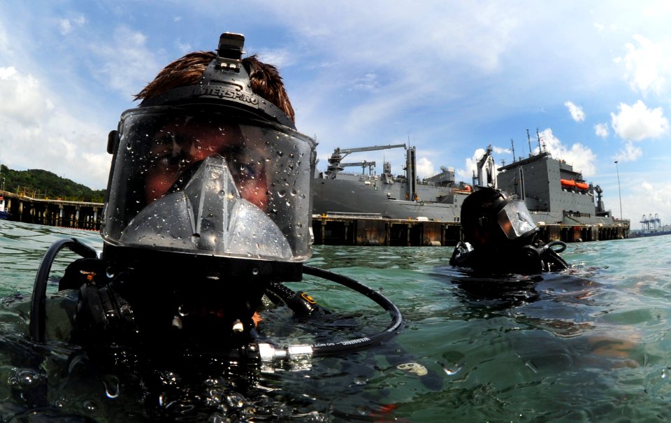 US Navy 110818-N-XD935-111 Navy Diver 2nd Class Ryan Arnold, left, assigned to Company 2-3 of Mobile Diving and Salvage Unit (MDSU) 2
