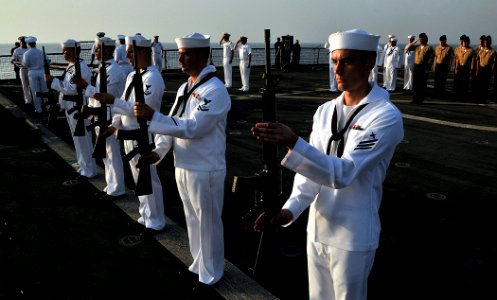 US Navy 110822-N-AG285-363 Sailors assigned to the ceremonial guard detail render honors during a burial at sea ceremony for three U.S. Navy veter photo