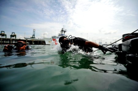 US Navy 110819-N-KB666-173 Cpl. Pinel Mepaquito, a Panamanian navy diver, enters the water during joint dive operations with divers assigned to Mob