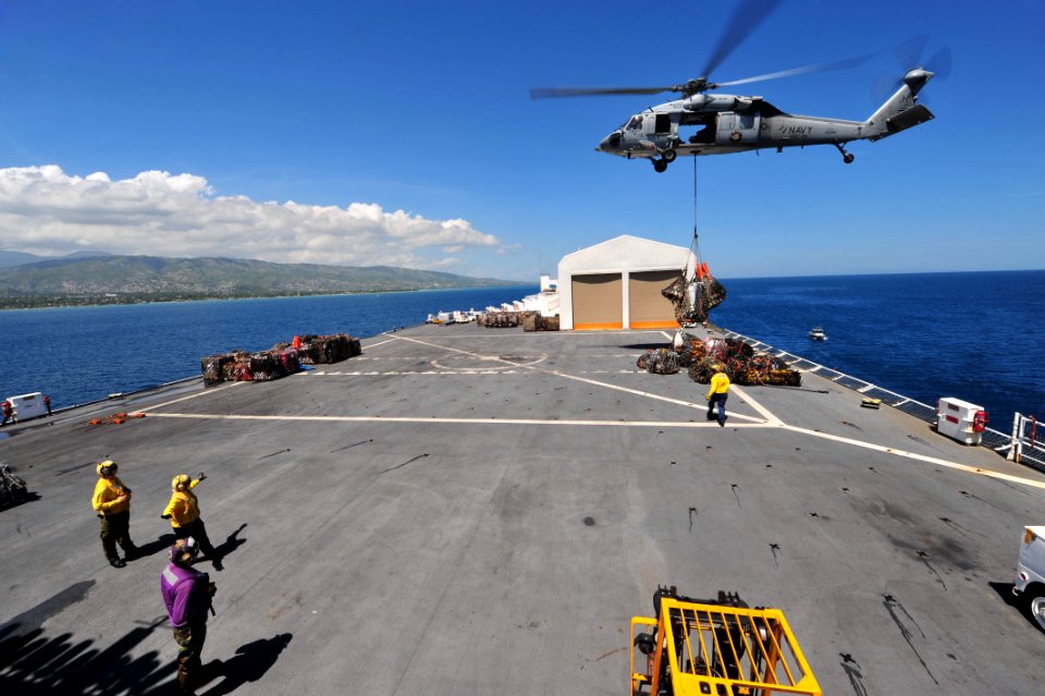 US Navy 110818-F-NJ219-016 Sailors assigned to the Chargers of Helicopter Sea Combat Squadron (HSC) 26 guide an MH-60S Sea Hawk helicopter to a pal