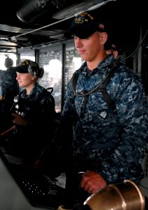 US Navy 110820-N-GH121-047 Boatswain's Mate Seaman Adam Spaulding mans the helm aboard the amphibious dock landing ship USS Whidbey Island (LSD 41) photo