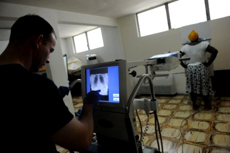 US Navy 110818-F-ET173-251 Lt. Cmdr. Andrew Sellers, from Chesapeake, Va., reviews an X-ray at the Killick Haitian Coast Guard Base surgical screen
