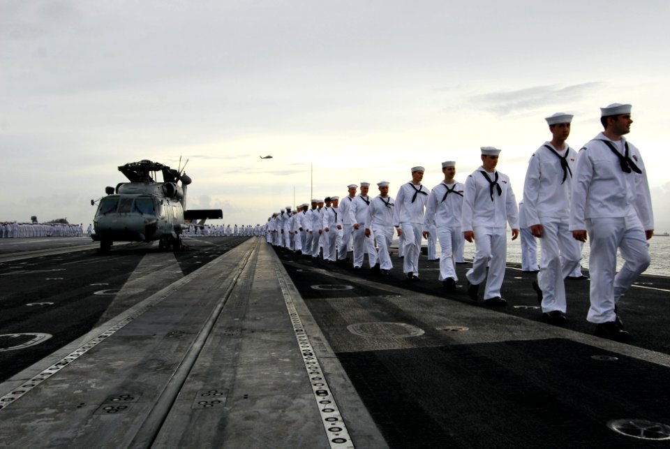 US Navy 110825-N-AW206-019 Sailors aboard USS George Washington (CVN 73) man the rails as the ship returns to Fleet Activities Yokosuka